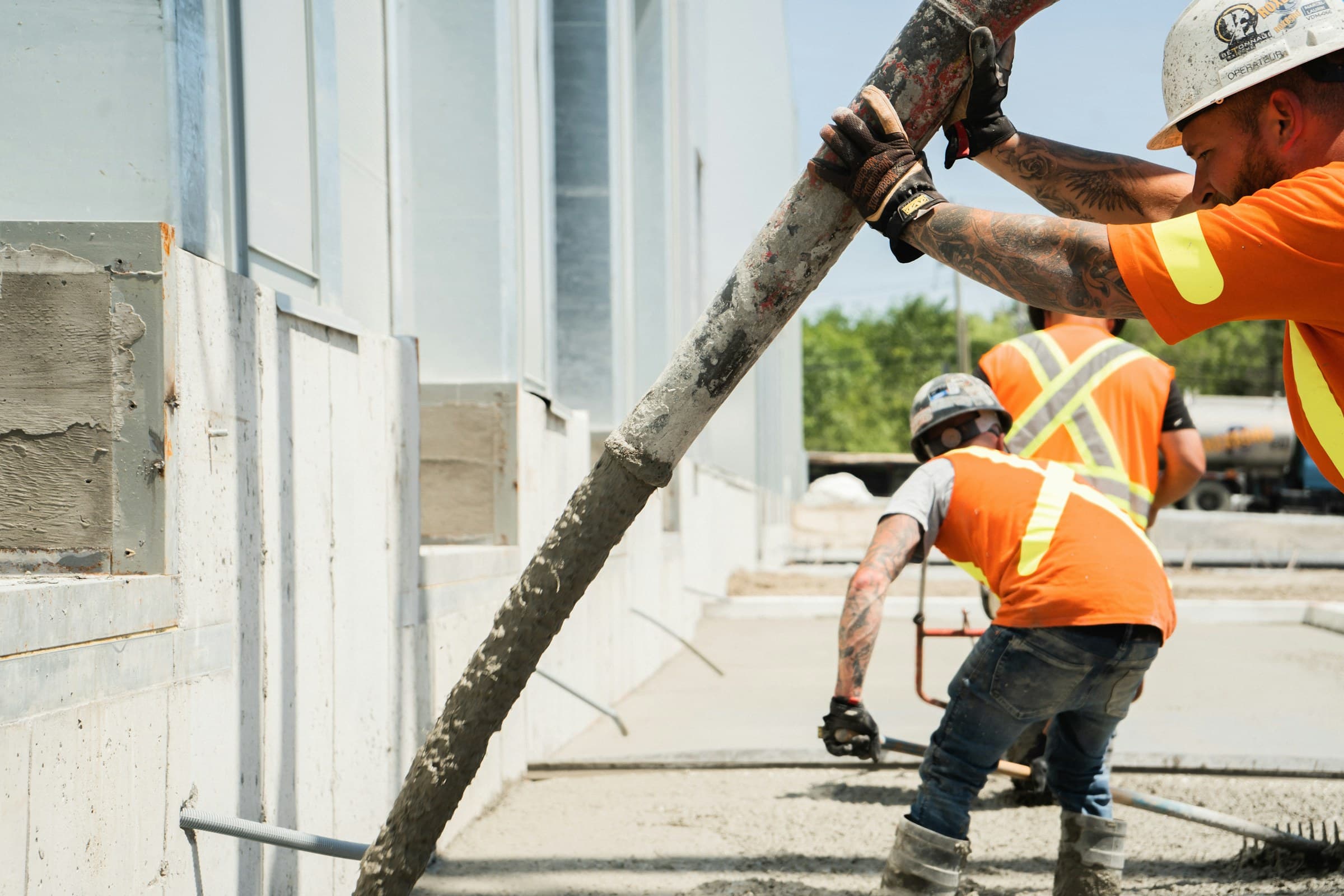 Crew finishing a large commercial concrete slab